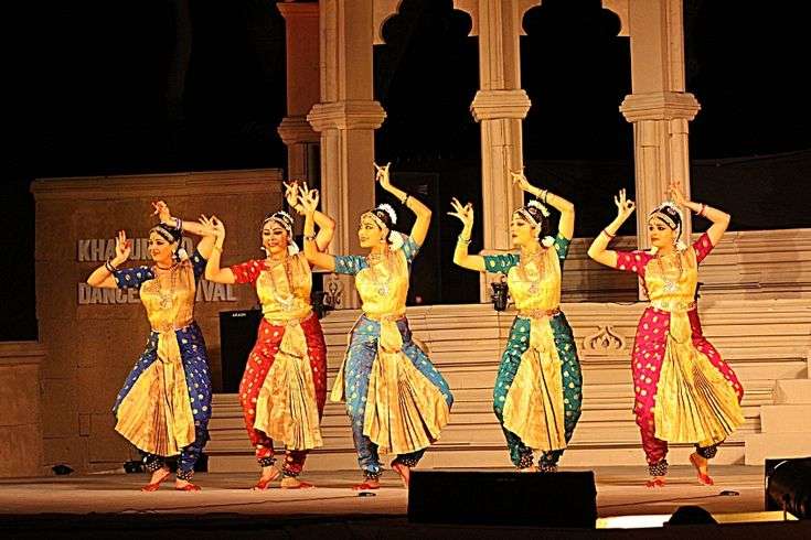 Khajuraho Dance Festival 2025: A Celebration of Culture, Art, and History

The Khajuraho Dance Festival 2025 promises to be an unforgettable journey into the heart of Indian classical dance. Nestled amidst the architectural grandeur of Khajuraho, this festival is one of the most celebrated cultural events in India. Known for its awe-inspiring temples, intricate sculptures, and vibrant cultural heritage, Khajuraho transforms into a dazzling stage where artists from across the country and beyond gather to showcase their talent.

If you’re looking to experience a fusion of history, culture, and traditional dance forms, the Khajuraho Dance Festival is a must-attend event. Let’s dive into the details of this festival, its significance, and why you shouldn’t miss it in 2025.

What is the Khajuraho Dance Festival?
The Khajuraho Dance Festival is an annual event that celebrates Indian classical dance forms in the picturesque setting of Khajuraho, a UNESCO World Heritage Site in Madhya Pradesh. Held every year in the month of February or March, the festival is a week-long celebration that brings together some of the finest classical dancers and performers from across India and beyond. The performances take place against the backdrop of the stunning temples, which are renowned for their elaborate stone carvings depicting various deities, dancers, and celestial beings.

The festival is a tribute to the rich cultural history of Khajuraho, which dates back to the Chandela dynasty (10th to 12th century). The temples here are famous for their unique architectural style and are adorned with intricate sculptures that depict scenes of divine and earthly life, including many dancing figures. This vibrant setting makes the Khajuraho Dance Festival not just a celebration of dance but also an immersive experience into the region’s cultural and architectural heritage.

When is the Khajuraho Dance Festival 2025?
The Khajuraho Dance Festival 2025 will be held from February 20th to February 26th, 2025. The festival takes place every year in the first week of March or the last week of February, so 2025 is no exception. As you plan your trip, keep in mind that the dates coincide with the pleasant winter season in Khajuraho, which means you can expect cool, comfortable weather – perfect for soaking in the cultural extravaganza.

Why is the Khajuraho Dance Festival Important?
Khajuraho’s rich cultural heritage and its spectacular temples make the city one of India’s most historically significant places. The Dance Festival plays a vital role in preserving and promoting classical Indian dance forms that are an integral part of India’s art and culture. The festival also serves as a platform for both established and emerging dancers to showcase their skills and keep these ancient art forms alive for generations to come.

For visitors, the festival offers a chance to experience the ancient temples up close, while enjoying the beauty of classical dance performances. It's a fusion of art, architecture, and spirituality that provides an enriching experience. The festival highlights India’s rich cultural diversity, with performances that span different classical dance traditions, from Bharatanatyam to Odissi, Kathak, Kuchipudi, and more.

Highlights of the Khajuraho Dance Festival 2025
Classical Dance Performances
One of the biggest draws of the Khajuraho Dance Festival is, of course, the mesmerizing classical dance performances. The festival showcases several different forms of classical dance, each with its own unique rhythm, movements, and storytelling tradition. These include:

Bharatanatyam: Known for its graceful movements, intricate footwork, and expressive storytelling, Bharatanatyam is one of the oldest and most revered dance forms in India.
Kathak: This dance form, originating from North India, features intricate footwork, spins, and dramatic storytelling through facial expressions and body movements.
Kuchipudi: Known for its fluidity and grace, Kuchipudi blends drama, dance, and music, and is famous for its portrayal of mythological themes.
Odissi: One of the oldest surviving dance forms, Odissi is characterized by its graceful, curving movements and intricate footwork, often accompanied by devotional music.
Stunning Temple Backdrop
The Khajuraho temples, built between 950 and 1050 CE, serve as a breathtaking backdrop for the dance performances. The temples are known for their striking sculptures, including those of gods, animals, dancers, and lovers, which provide an inspiring setting for the festival. The golden light of the setting sun casts a magical glow on the temples as the dancers perform, adding a spiritual and ethereal element to the experience.

Dazzling Lighting and Ambiance
The festival also features spectacular lighting that illuminates the temples at night, creating a mesmerizing atmosphere. The soft glow of the lights enhances the beauty of the intricate temple carvings while providing an enchanting setting for the dancers to perform. The combination of music, dance, and the illuminated temples creates an atmosphere that is both magical and immersive.

Workshops and Interactions
In addition to the performances, the Khajuraho Dance Festival also hosts workshops and interactive sessions where festival-goers can engage with the dancers and learn more about the intricacies of classical dance forms. These sessions offer a chance for enthusiasts and aspiring dancers to deepen their understanding of the art, as well as to get inspired by some of the best in the industry.

Cultural Extravaganza for All Ages
Whether you’re a dance enthusiast, a culture lover, or someone who enjoys exploring new places, the Khajuraho Dance Festival offers something for everyone. The festival’s performances and workshops cater to a wide range of audiences, from children to adults. The event is designed to celebrate the richness of Indian classical dance in a way that can be enjoyed by all, regardless of age or background.

Where to Stay During the Khajuraho Dance Festival
As Khajuraho is a popular tourist destination, there are a variety of accommodation options available for visitors. From luxury hotels to budget guesthouses, here are a few places to stay during the festival:

The Lalit Temple View Khajuraho: A luxury hotel offering a stunning view of the temples, providing a blend of modern amenities and traditional Indian hospitality.
Radisson Hotel Khajuraho: A well-known hotel with comfortable rooms, a swimming pool, and excellent dining options.
Khajuraho Huts: A budget-friendly option, offering a more rustic and peaceful experience.
Hotel Chandela: A mid-range hotel located close to the festival venues, offering good facilities and a comfortable stay.
Where to Eat in Khajuraho
Khajuraho offers a wide range of dining options that cater to both traditional Indian tastes and international flavors. During the festival, local food stalls and eateries spring up around the temple grounds, offering delicious snacks and meals. Here are a few places to try:

Raja’s Café: A popular spot for tourists, offering Indian and continental dishes with a view of the temples.
The Maharaja Restaurant: A local favorite for traditional Indian food and snacks.
Cafe de la Paix: Known for its laid-back ambiance and a variety of international dishes.
Final Thoughts
The Khajuraho Dance Festival 2025 promises to be a spectacular celebration of India’s rich cultural and artistic heritage. Whether you’re a lover of classical dance, history, or just in search of a unique cultural experience, this festival offers a chance to witness the fusion of music, dance, and spirituality like never before. With stunning performances against the backdrop of Khajuraho’s ancient temples, the festival invites visitors to immerse themselves in the heart of Indian tradition, history, and art.

So mark your calendars, book your tickets, and get ready to be a part of the magical Khajuraho Dance Festival 2025!